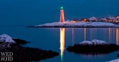lighthouse reflecting in harbor
