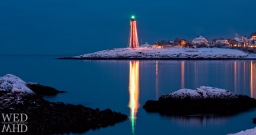 lighthouse reflecting in harbor